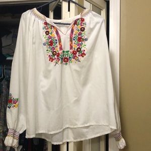 White blouse with floral embroidery.